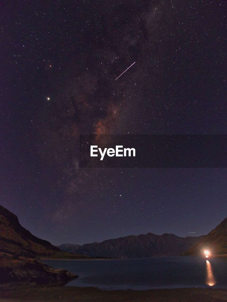 Scenic view of mountains against sky at night