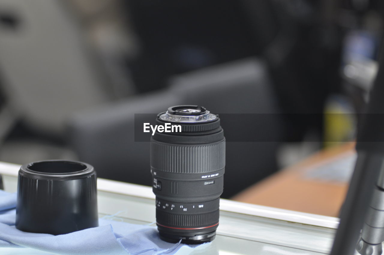 Close-up of camera lens on table