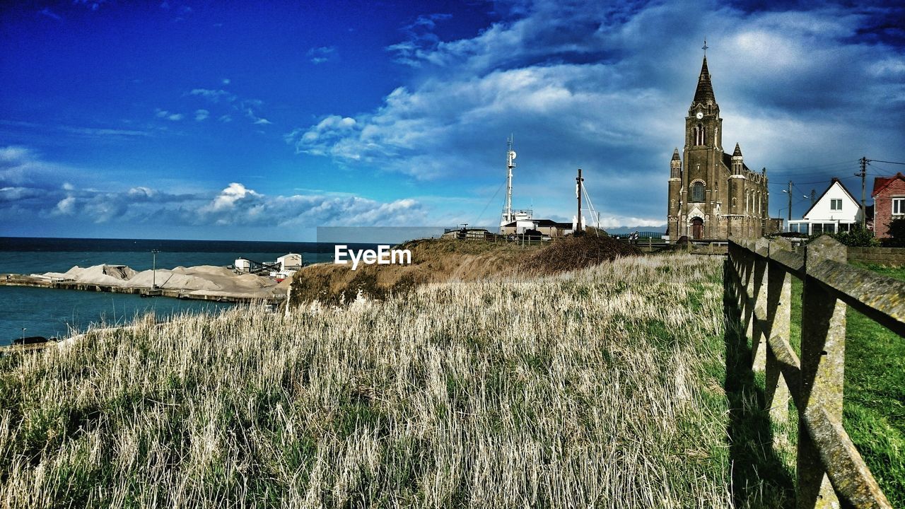 VIEW OF CALM SEA AGAINST CLOUDY SKY