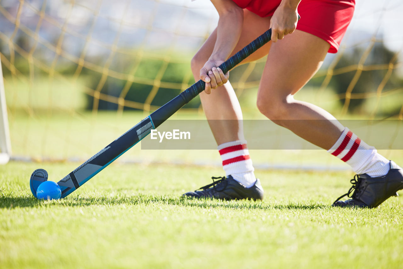 low section of man playing soccer on field