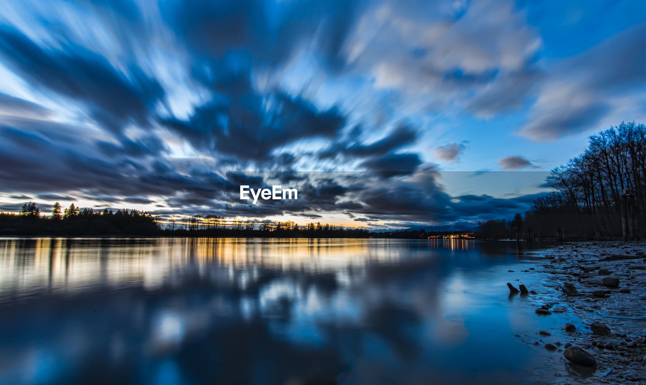 Scenic view of lake against sky at dusk