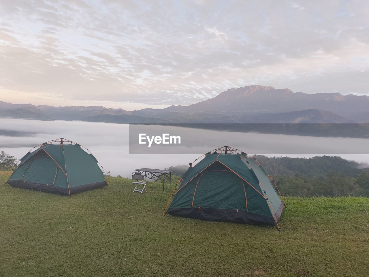 tent, camping, mountain, scenics - nature, environment, landscape, nature, sky, travel, adventure, beauty in nature, land, grass, travel destinations, trip, vacation, tranquility, holiday, mountain range, water, no people, leisure activity, tranquil scene, tourism, plant, non-urban scene, cloud, relaxation, lake, outdoors, day, idyllic, remote, summer, activity, hiking equipment