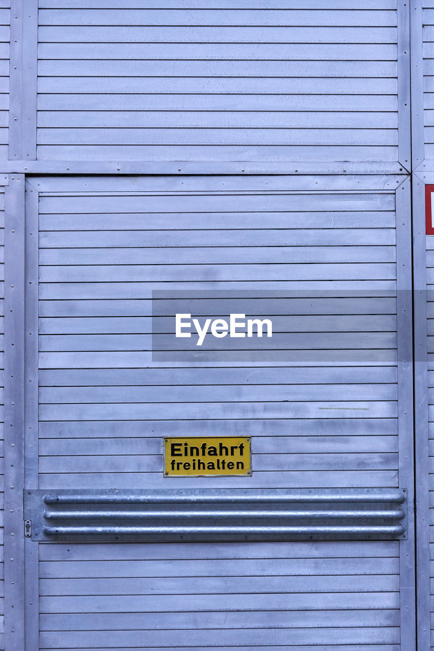 Text on closed gray door of garage