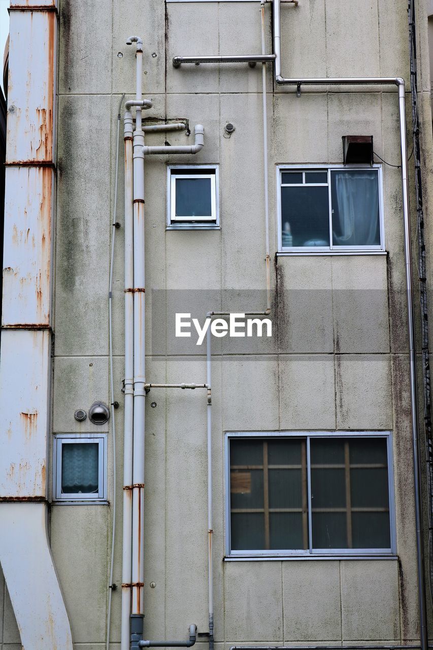 Low angle view of aging concrete residential building