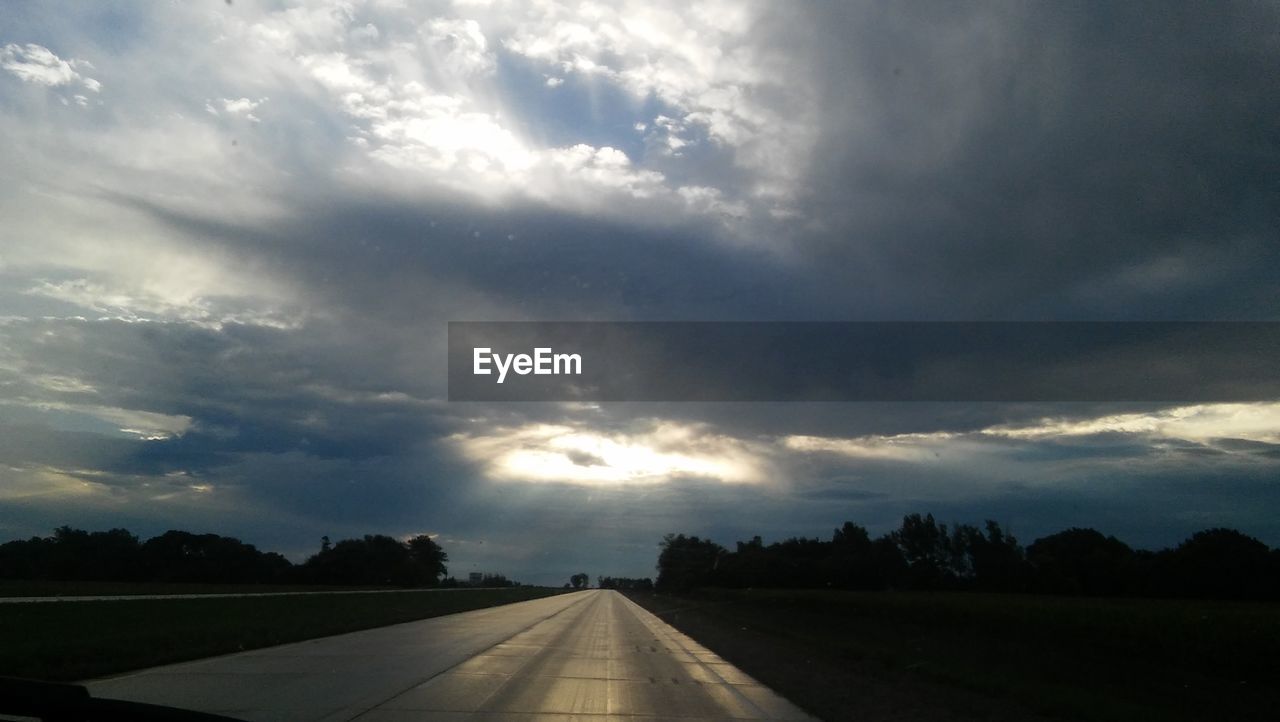 ROAD PASSING THROUGH LANDSCAPE AGAINST CLOUDY SKY