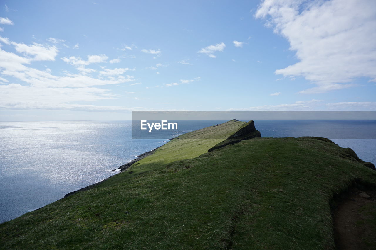 Scenic view of cliff against sea and sky