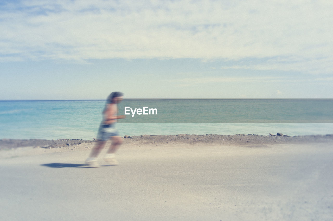 PERSON ON BEACH AGAINST SKY