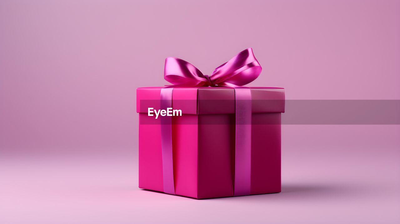 pink, gift, box, bow, ribbon, tied bow, gift box, celebration, studio shot, container, birthday present, purple, christmas present, colored background, wrapping paper, surprise, anniversary, holiday, event, indoors, birthday, magenta, emotion, red, single object, no people, wrapped, paper, present, violet, giving, wedding favors, positive emotion, petal, still life, copy space, pink background, love, decoration, valentine's day