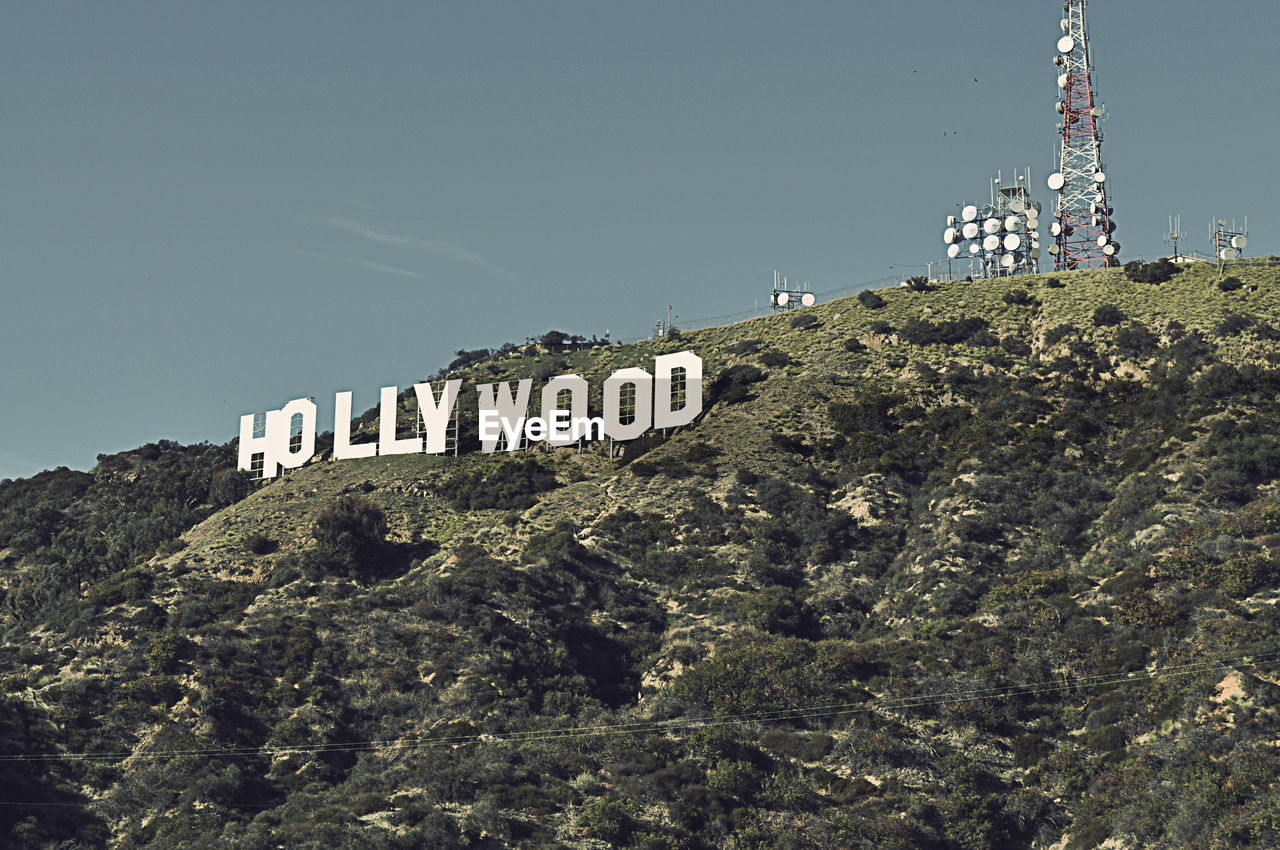 Low angle view of hollywood on mountains against sky