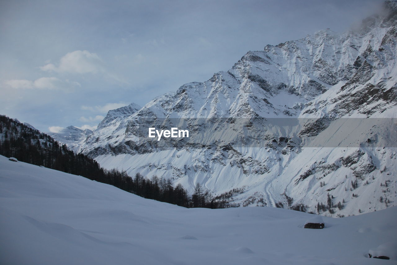 Scenic view of snowcapped mountains against sky