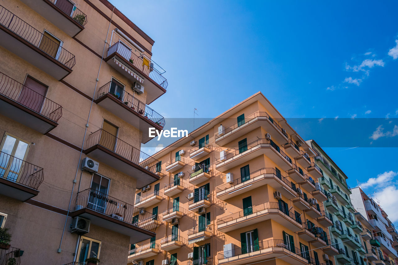 low angle view of residential building against blue sky