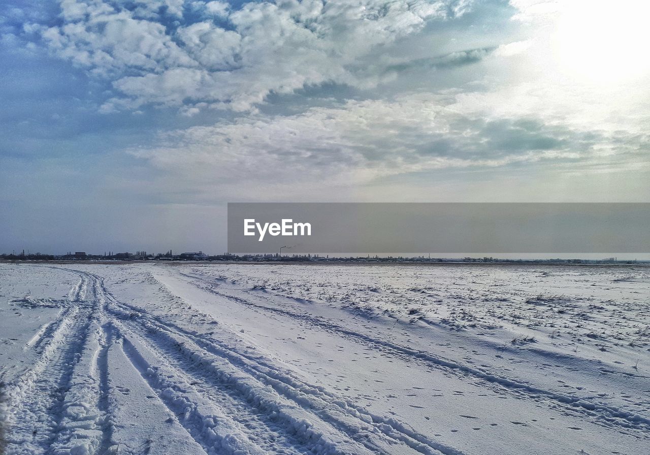 SNOW COVERED LANDSCAPE AGAINST SKY