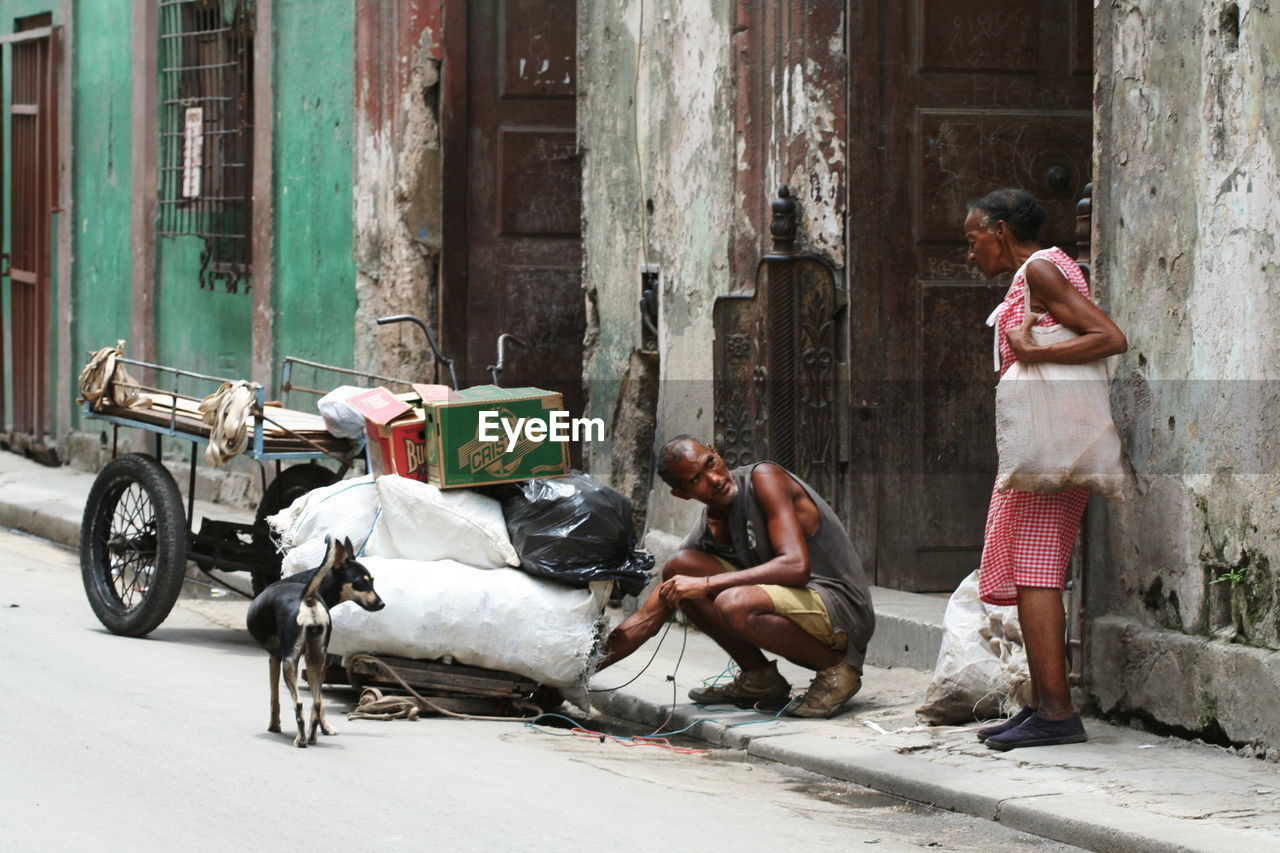 MAN SITTING IN A CITY