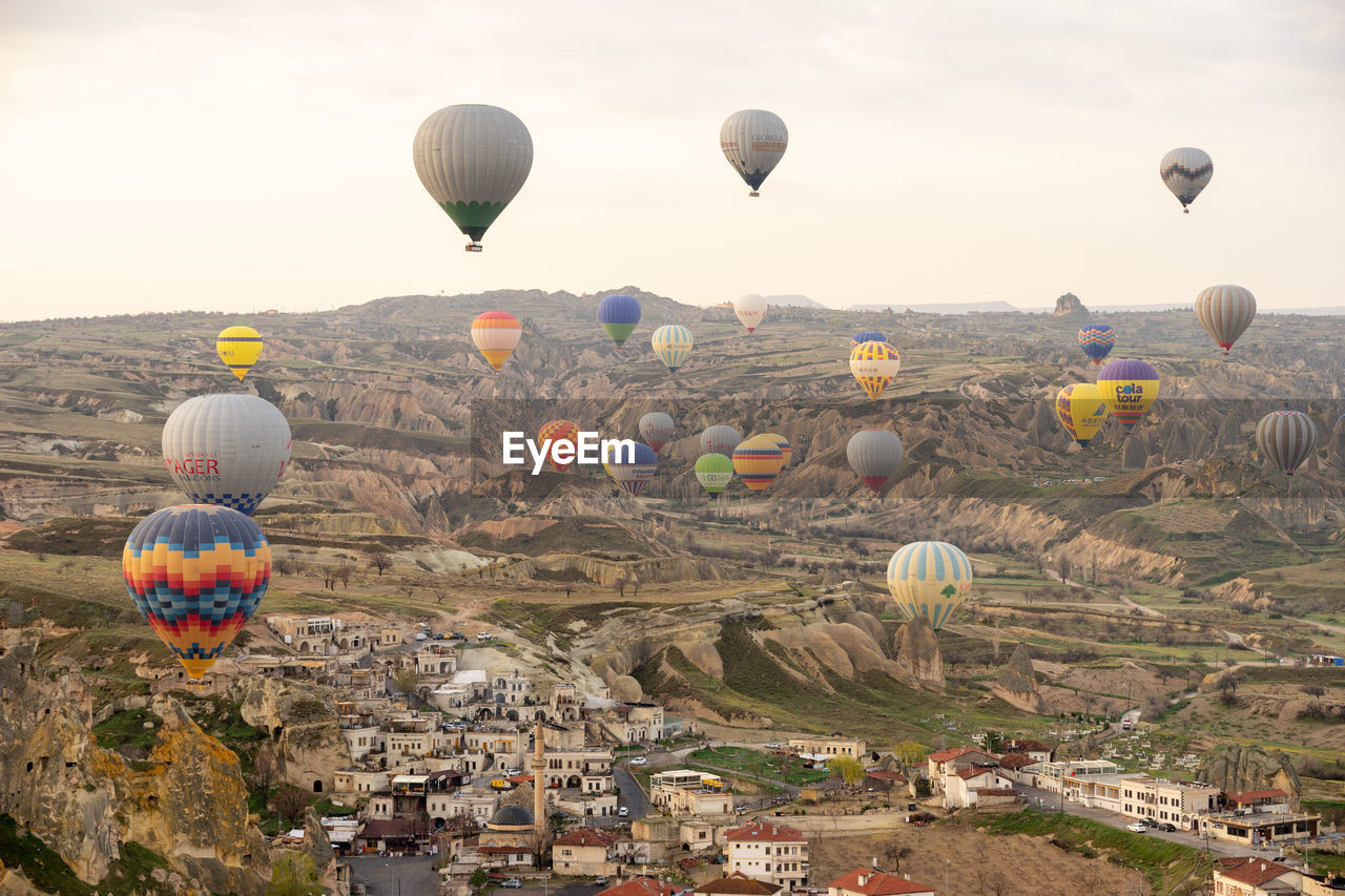 HOT AIR BALLOONS FLYING ABOVE LANDSCAPE