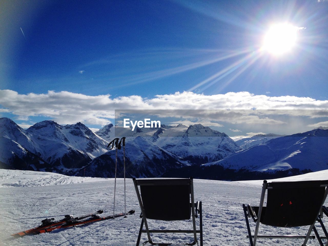 Scenic view of snowcapped mountains against blue sky