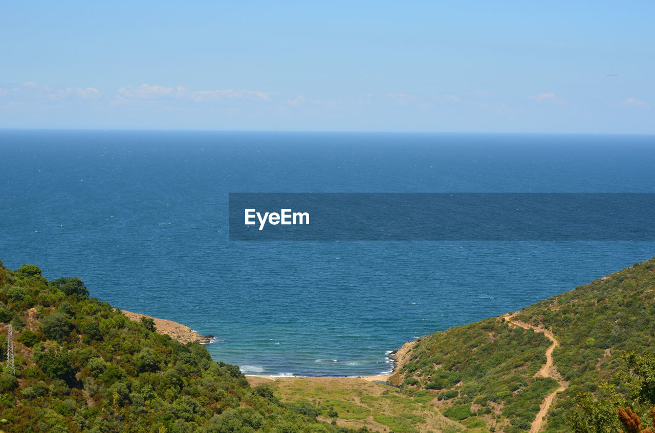 sea, water, scenics - nature, beauty in nature, horizon over water, horizon, sky, coast, tranquility, land, tranquil scene, nature, cliff, beach, ocean, plant, day, blue, shore, no people, high angle view, body of water, idyllic, bay, terrain, non-urban scene, hill, outdoors, travel, travel destinations, coastline, environment, tree, landscape, vacation, tourism