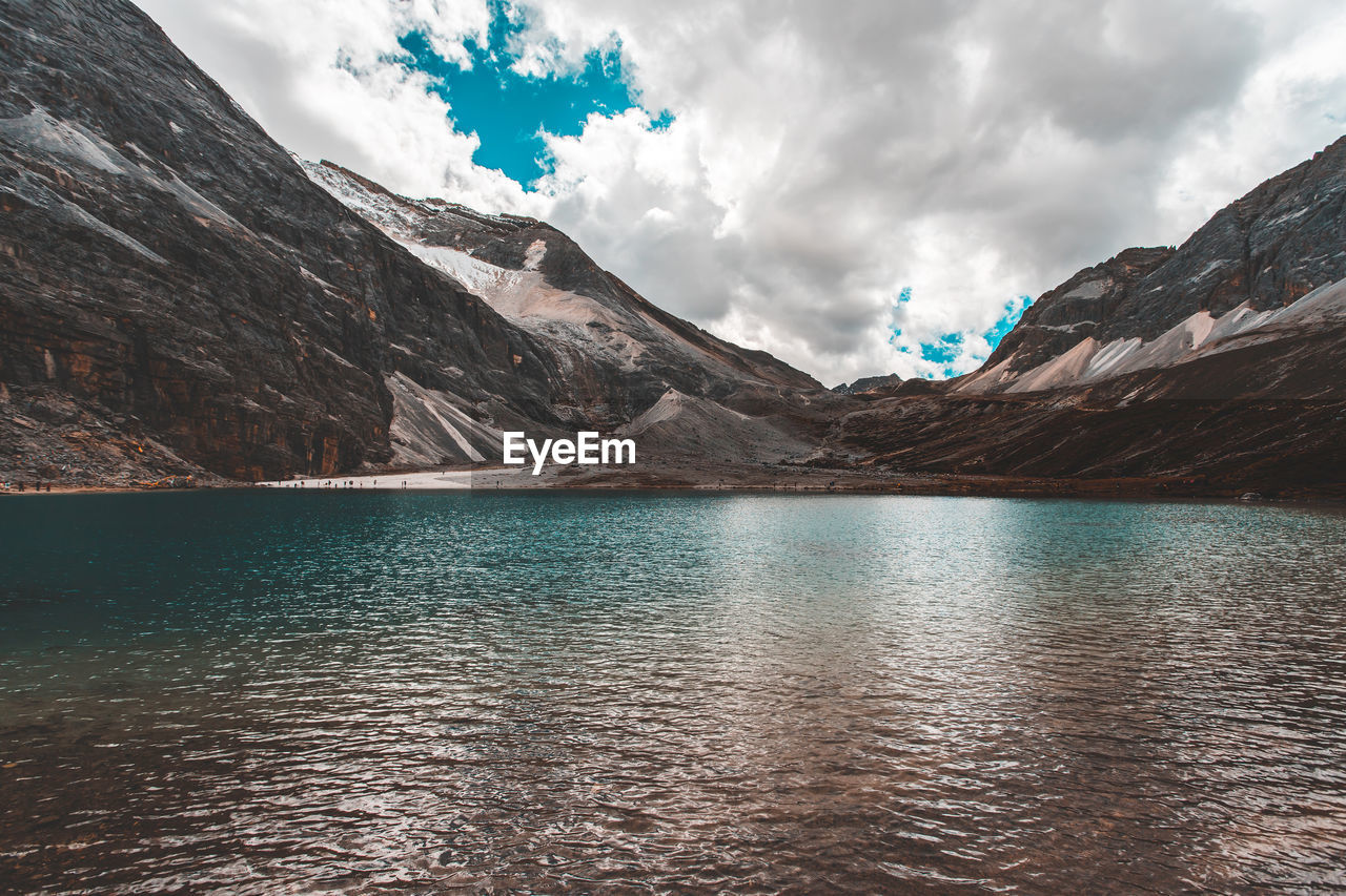 Scenic view of lake and mountains against sky