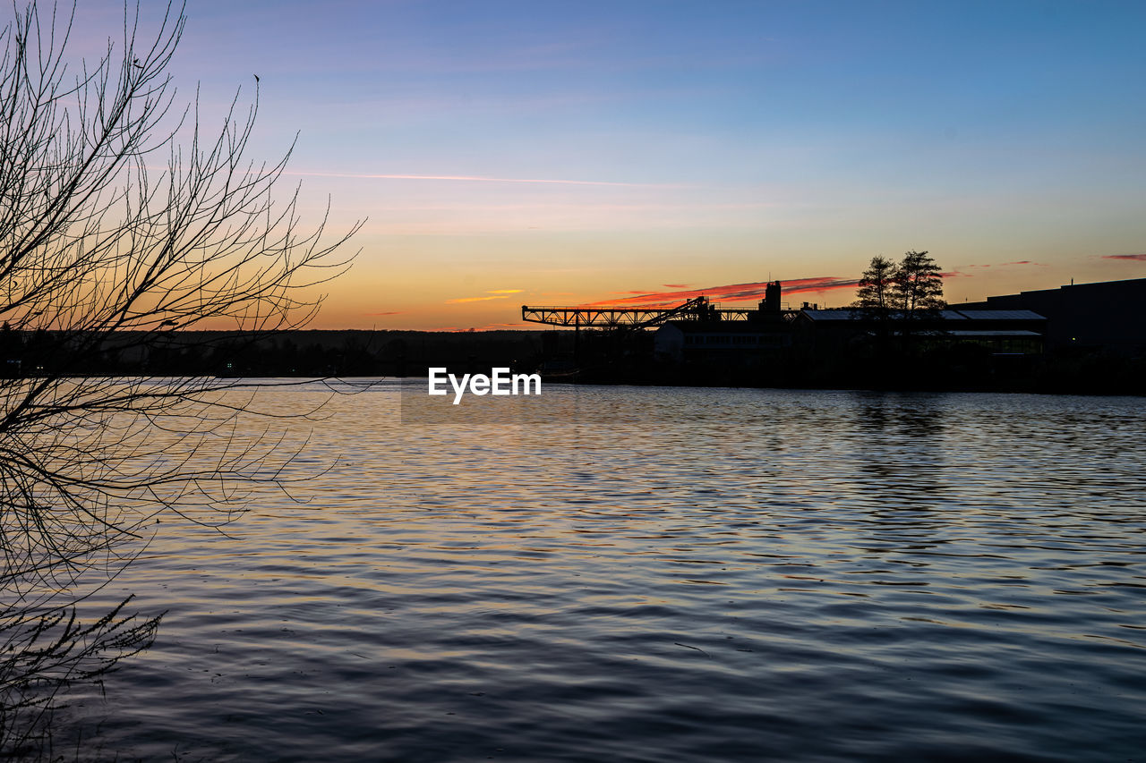 SCENIC VIEW OF LAKE AGAINST SKY AT SUNSET