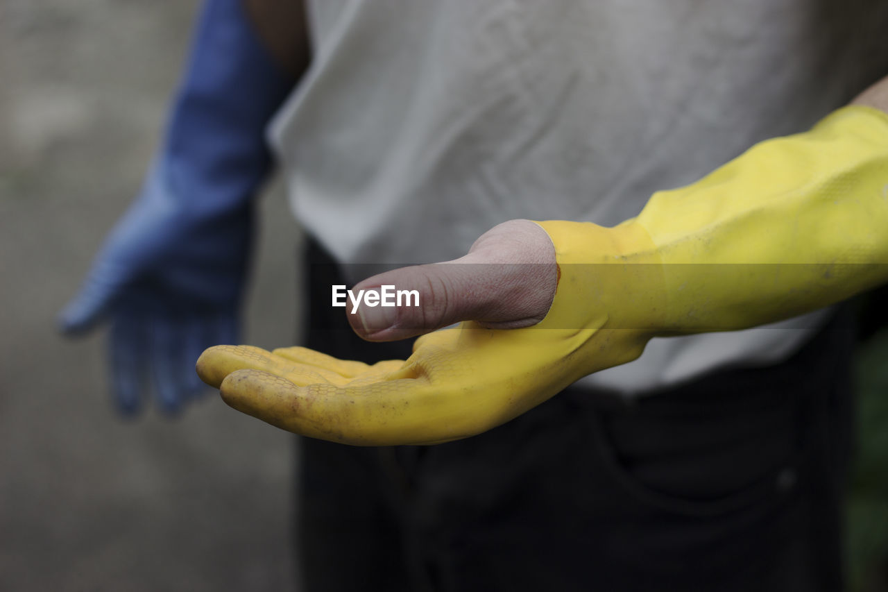 Midsection of man holding fruit