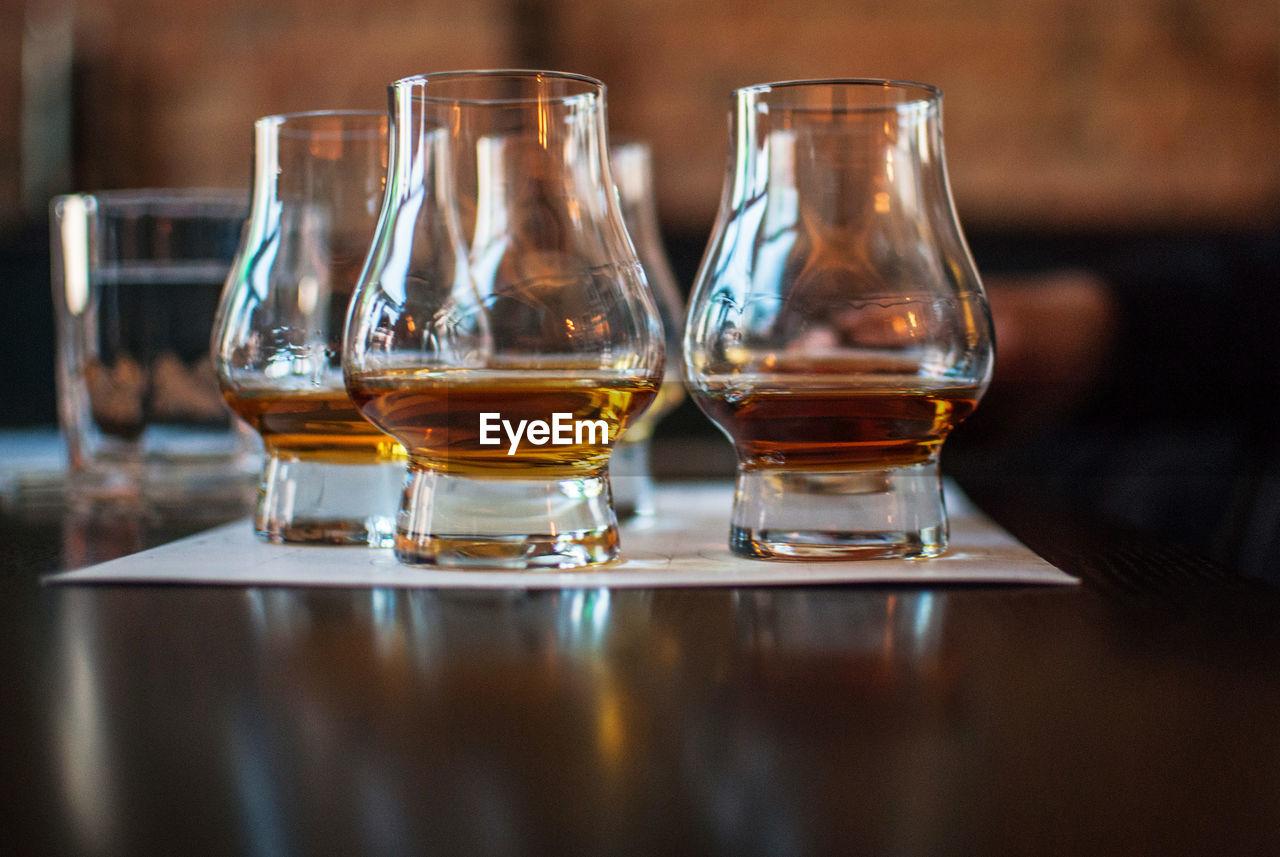 Close-up of whiskey glasses on table in bar