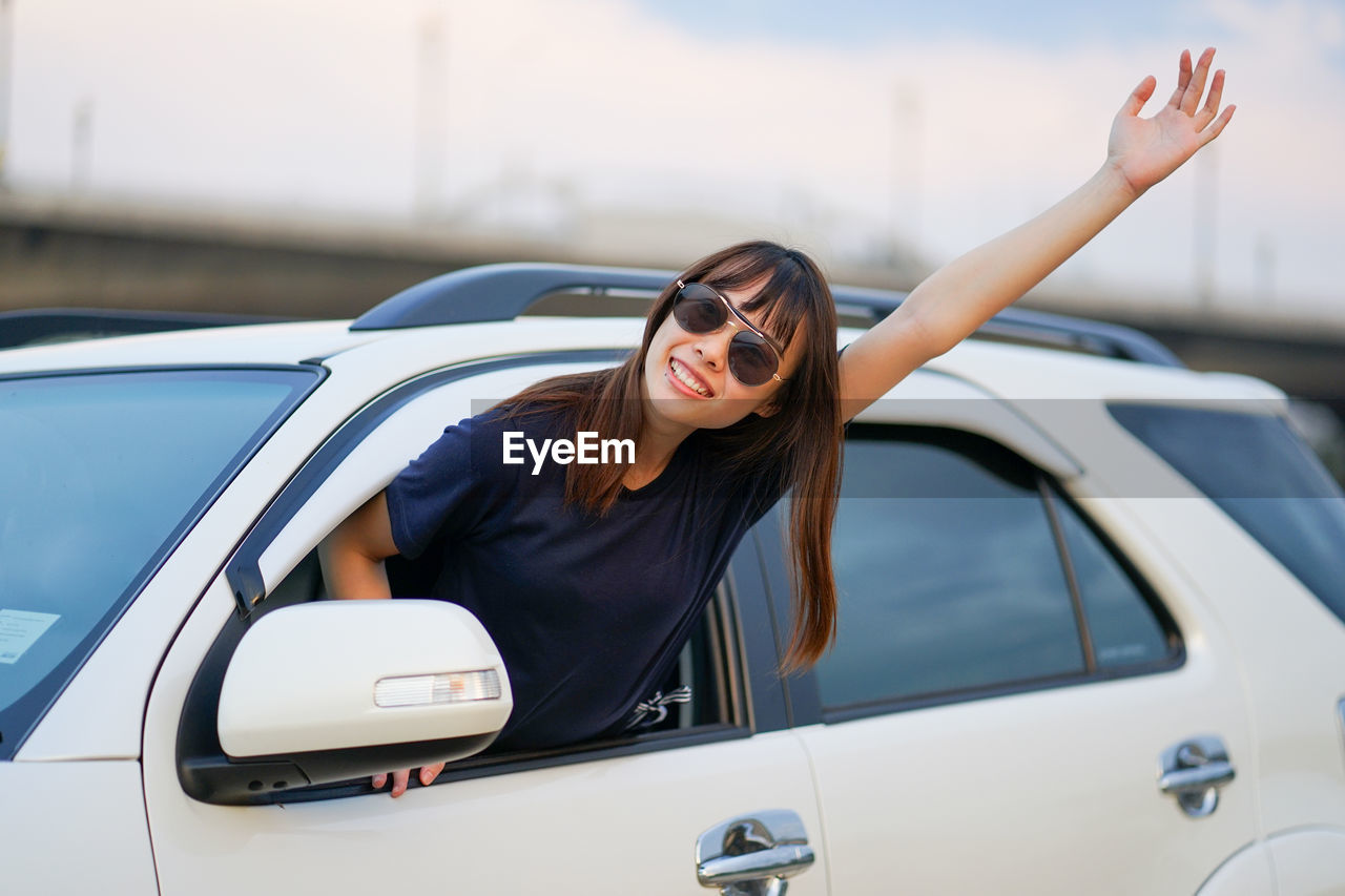 Woman wearing hat while sitting in car