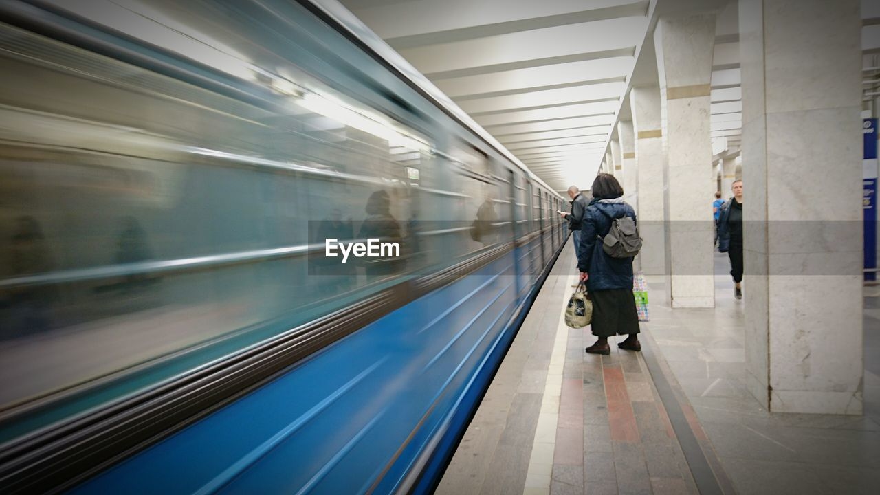 Rear view of people at subway station