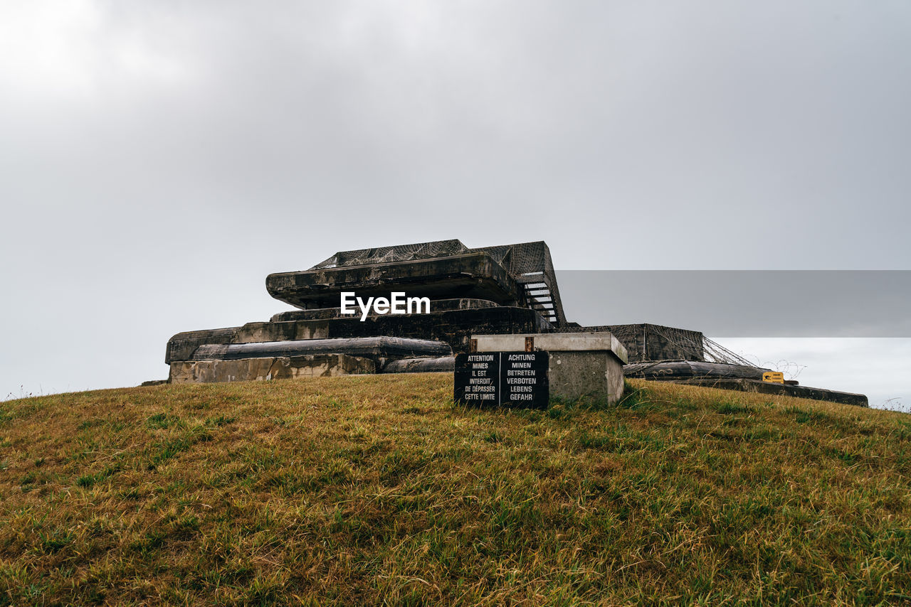 BUILT STRUCTURE ON LAND AGAINST SKY