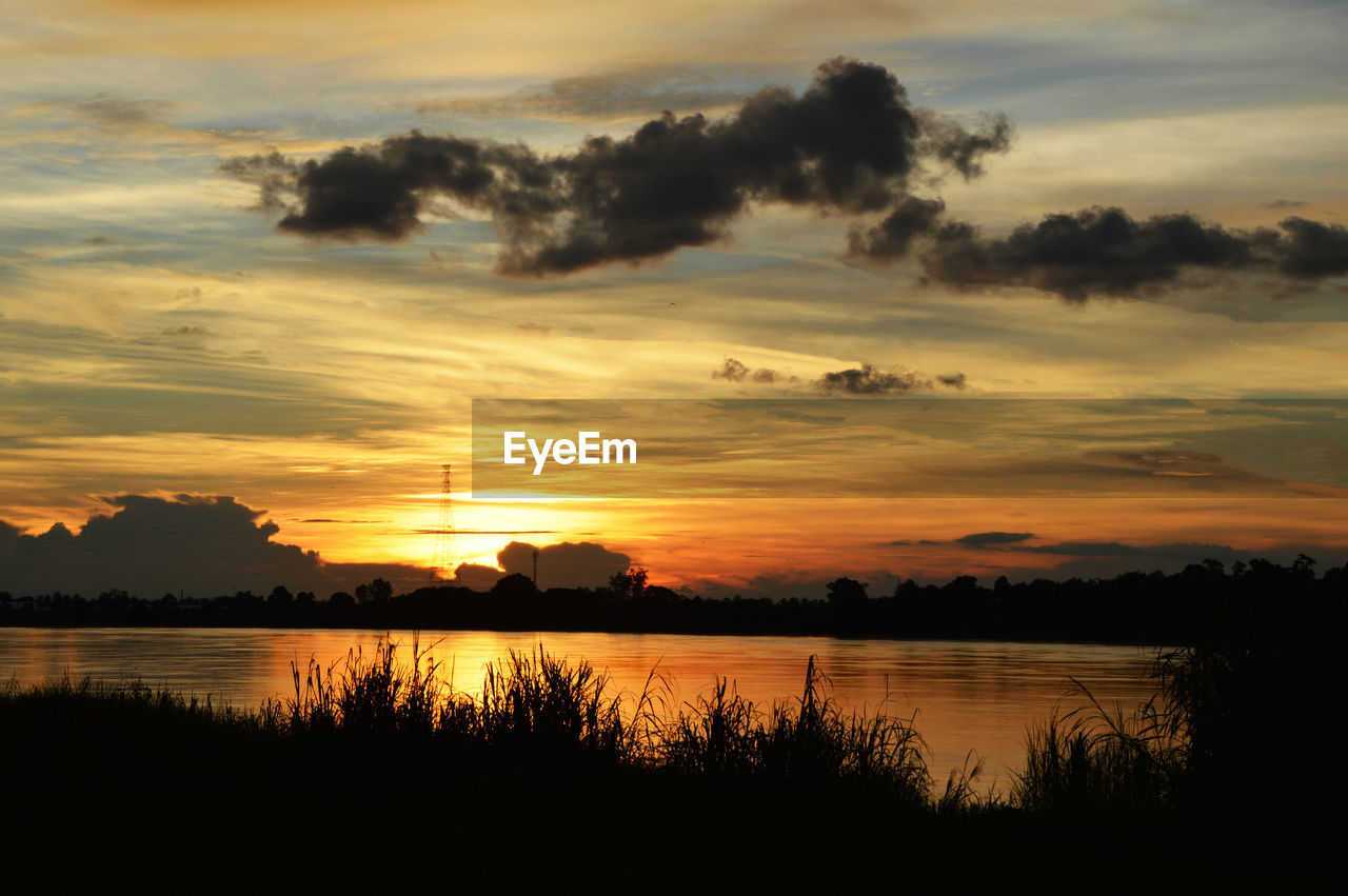 SCENIC VIEW OF LAKE AGAINST ORANGE SKY DURING SUNSET