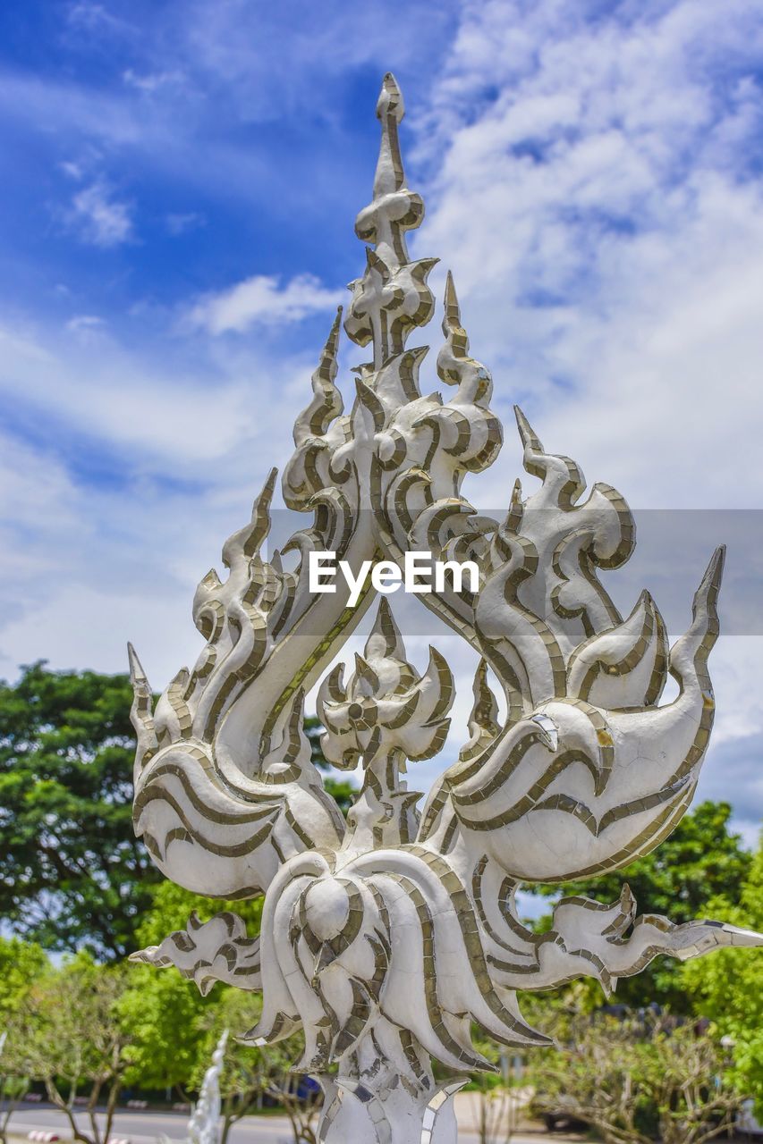 Low angle view of statue against sky