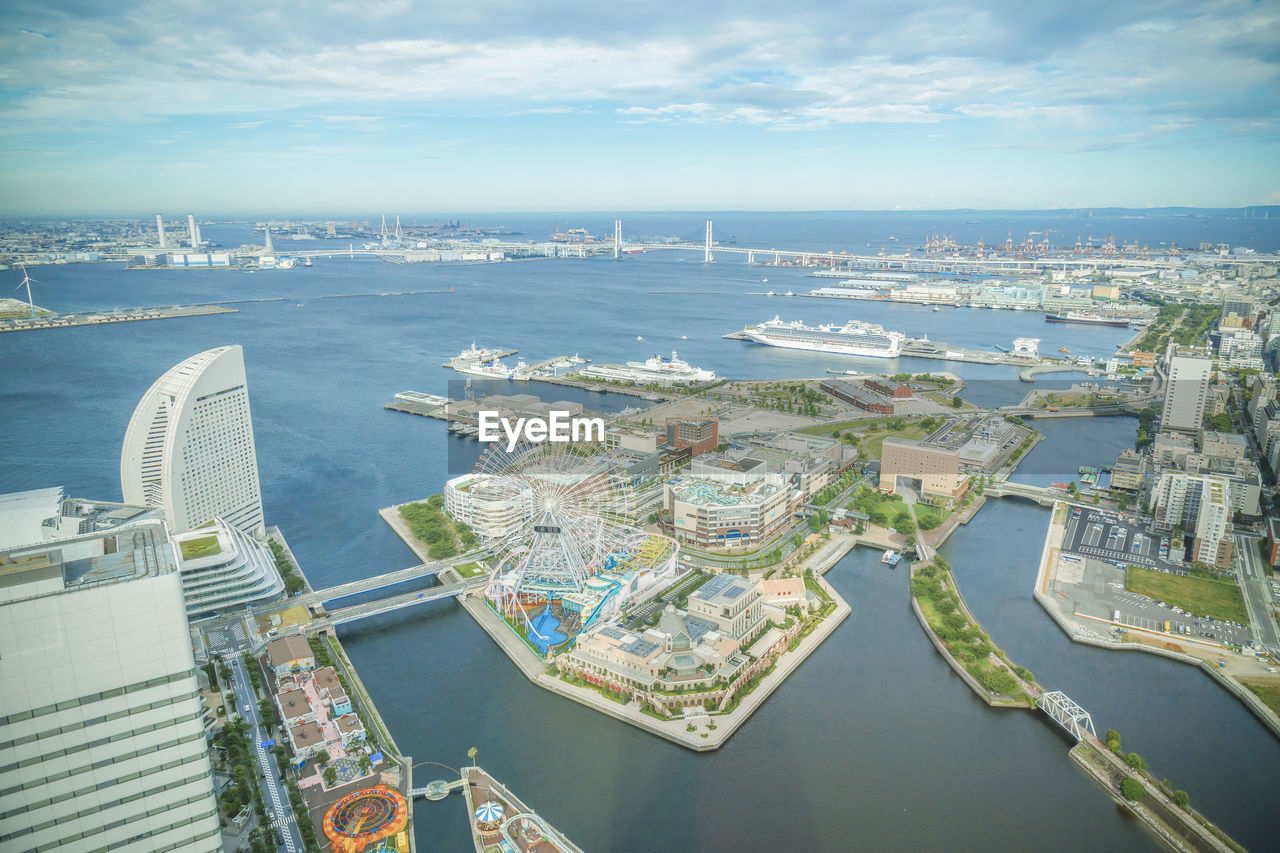 High angle view of bay and cityscape against sky