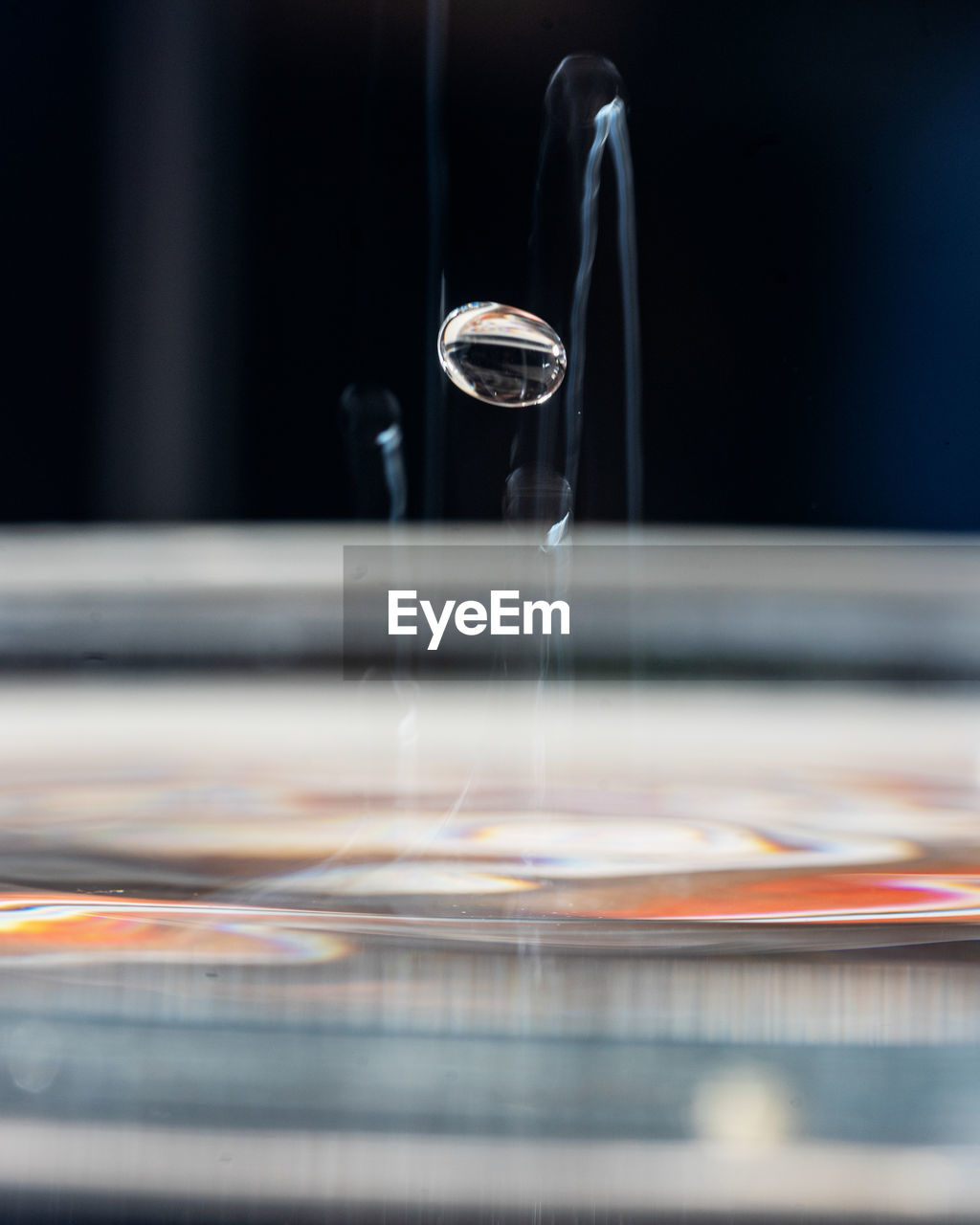 close-up of water drop falling on table