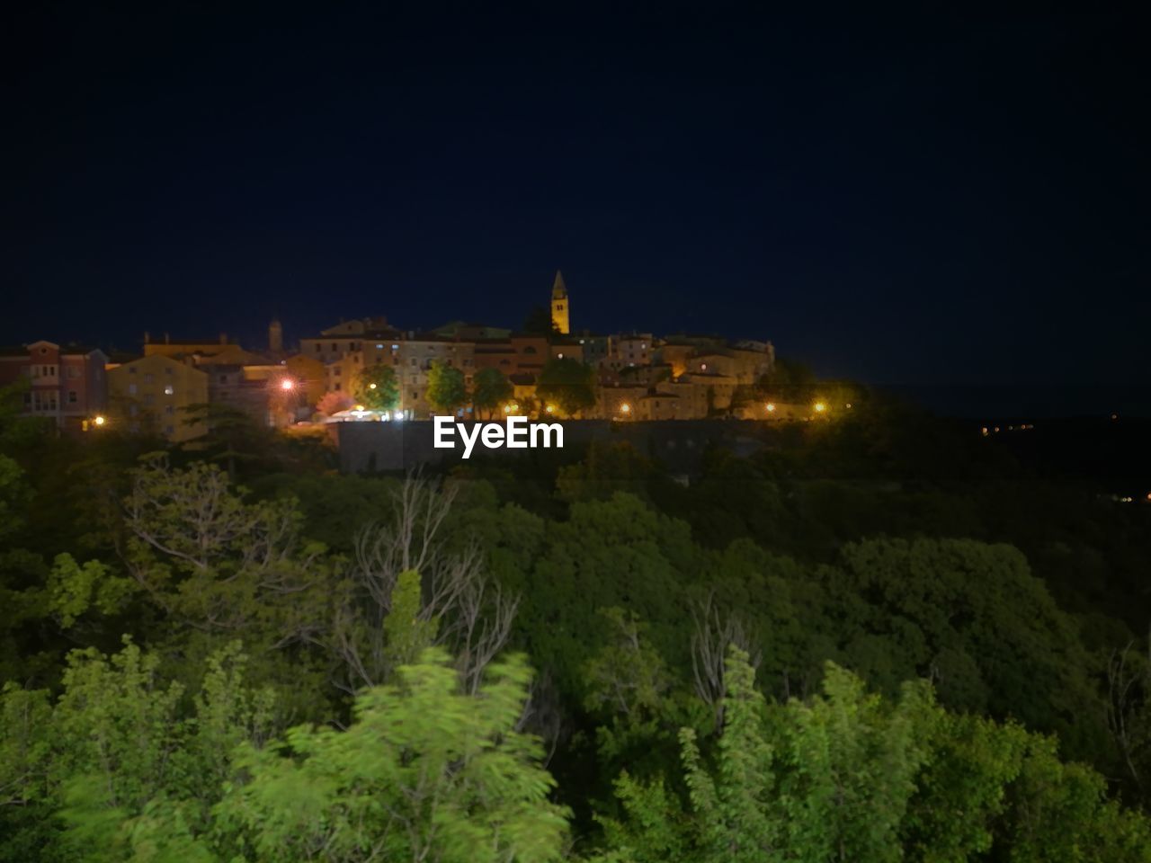 VIEW OF ILLUMINATED BUILDINGS AT NIGHT