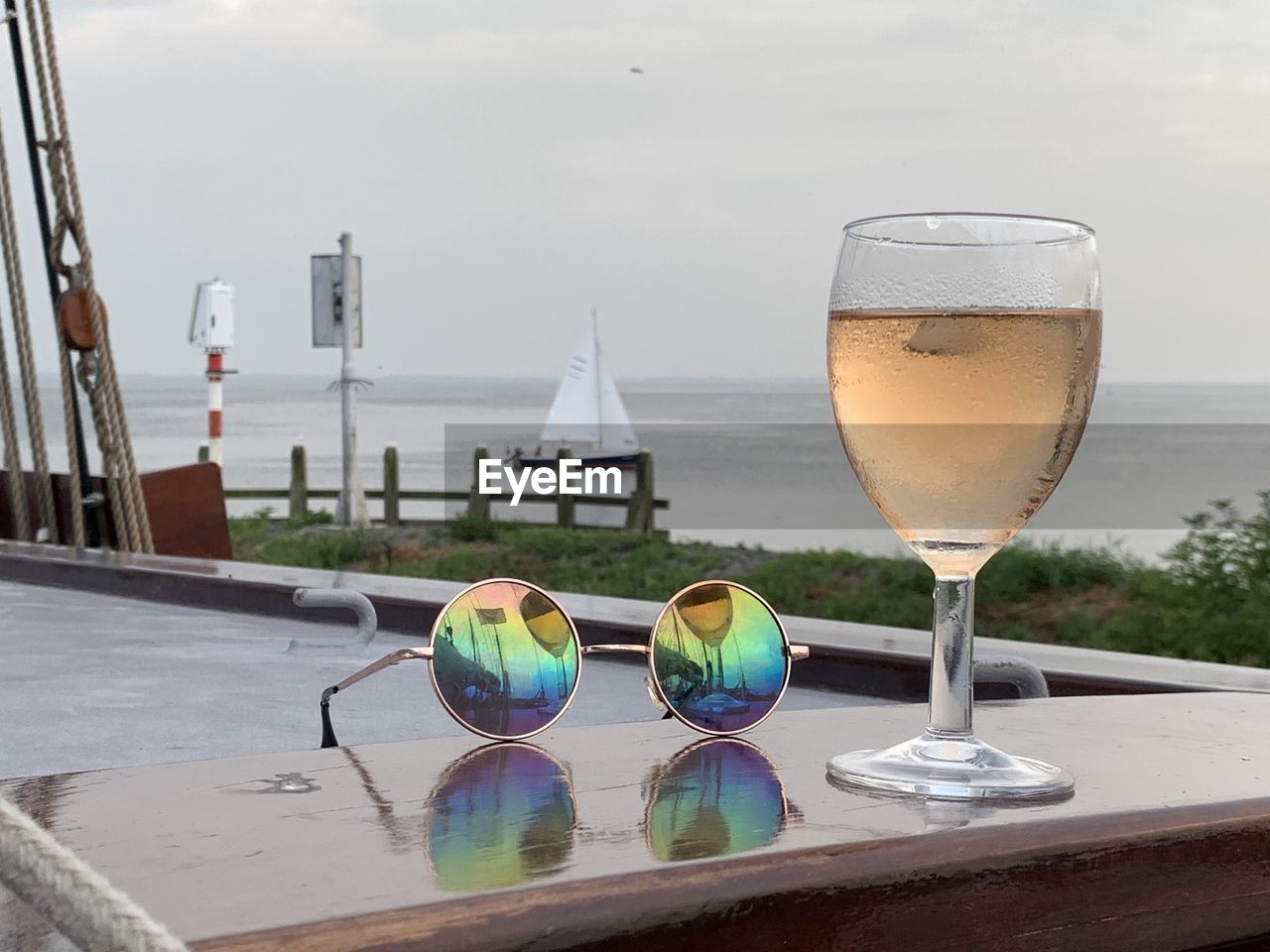 CLOSE-UP OF WINE GLASSES ON SWIMMING POOL