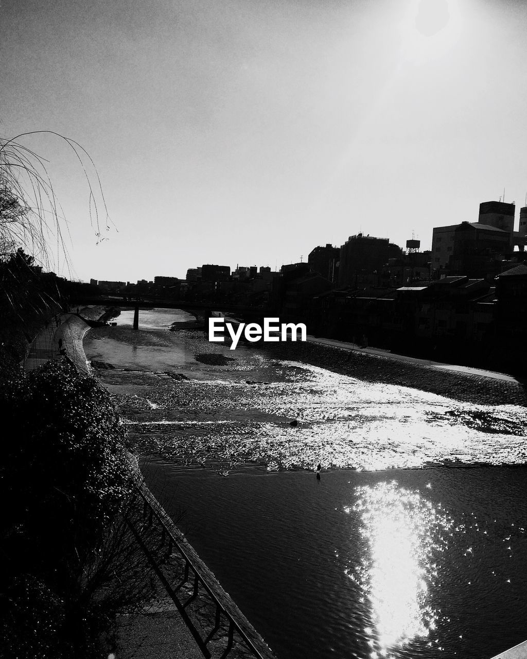 VIEW OF RIVER WITH BUILDINGS IN BACKGROUND