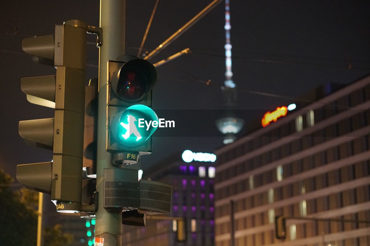 Low angle view of road signal at night