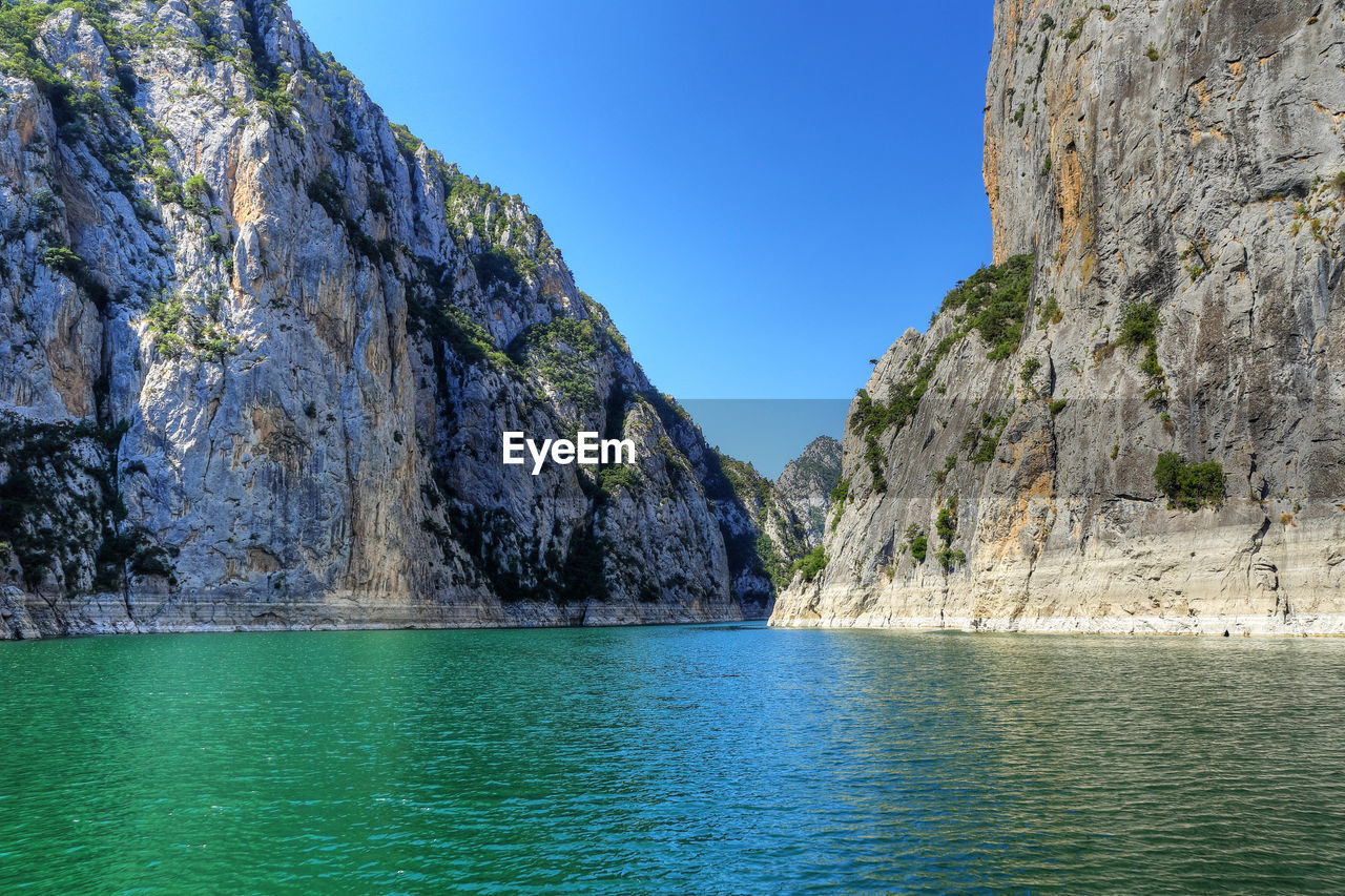 Scenic view of sea against clear blue sky