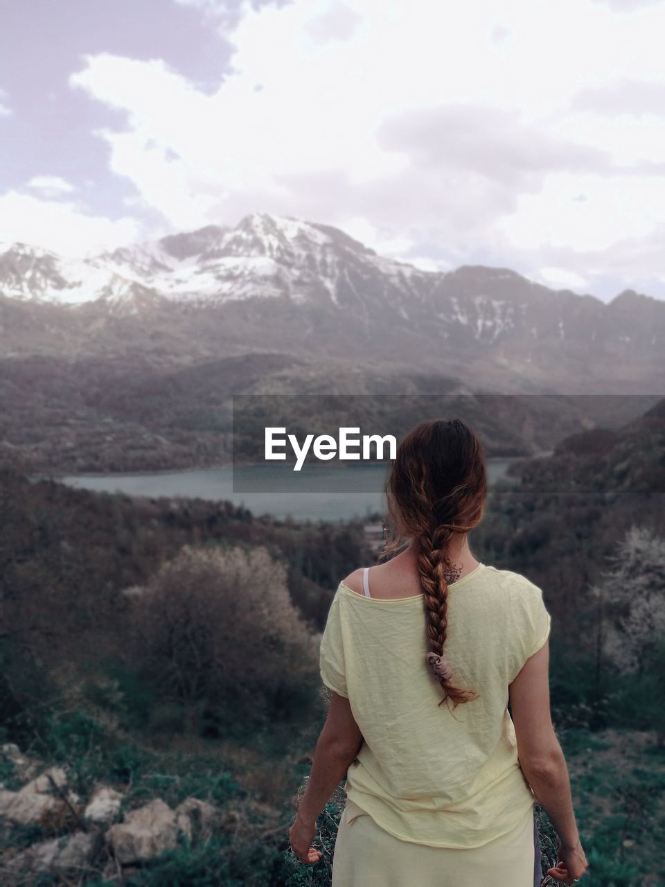 Rear view of woman standing on landscape