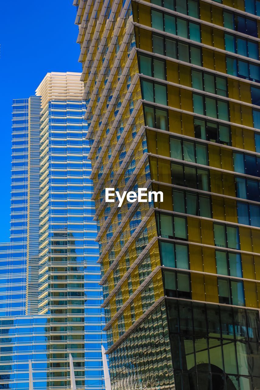 Exterior of modern buildings against clear sky in city
