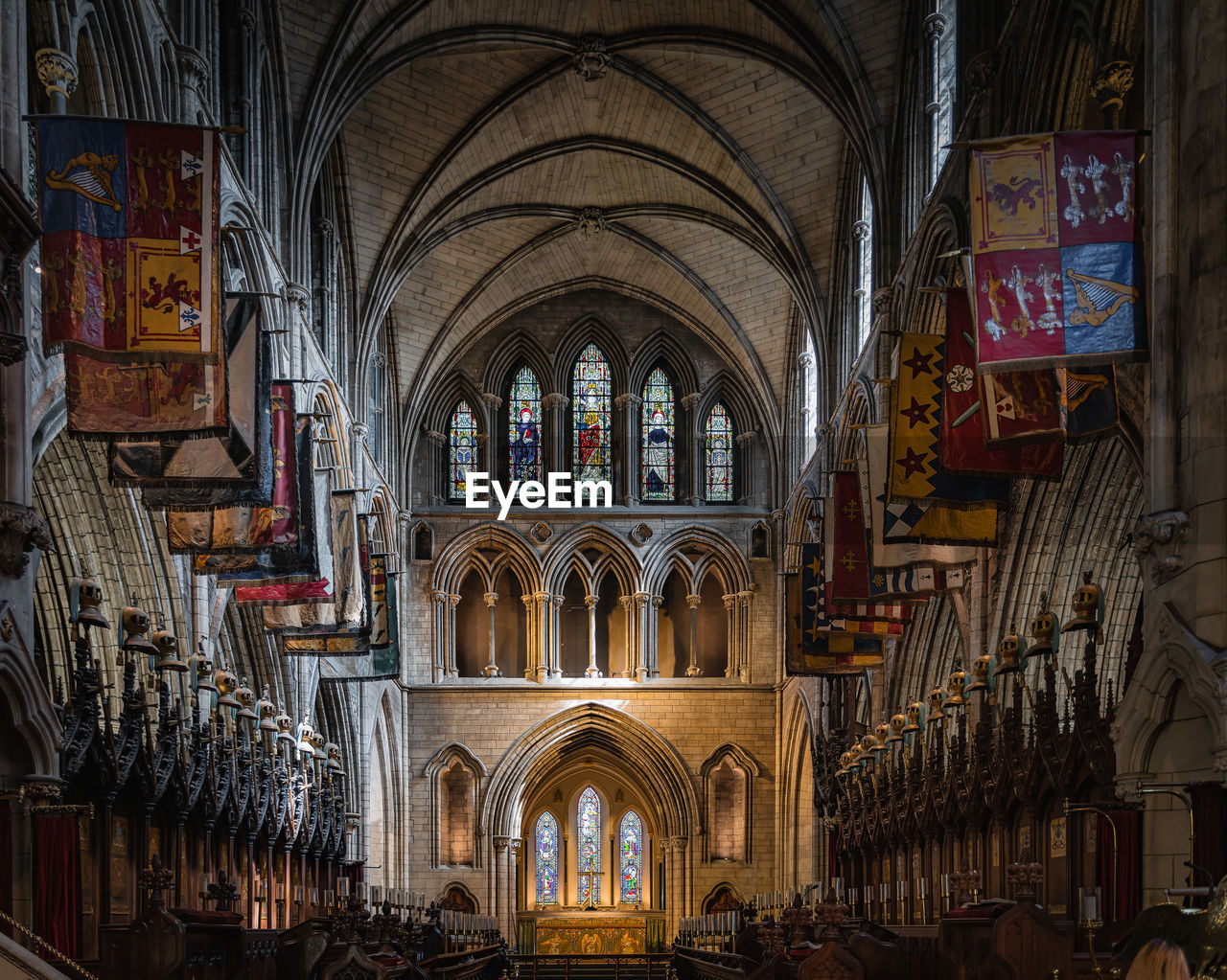 Flags and pennants on both sides of illuminated altar in st. patricks cathedral, ireland