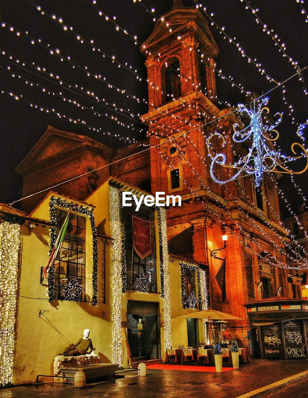 ILLUMINATED CLOCK TOWER IN CITY