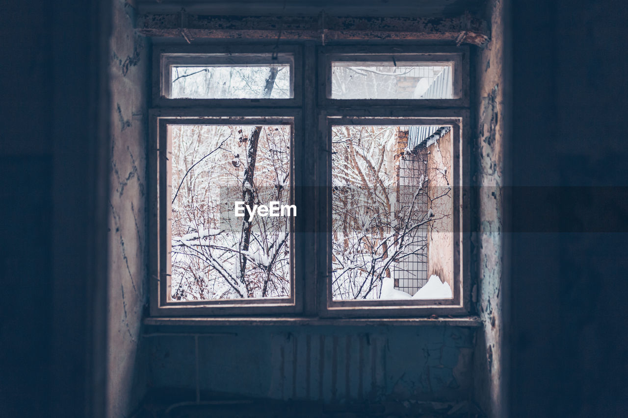 Damaged window of abandoned building in chernobyl zone at pripyat 