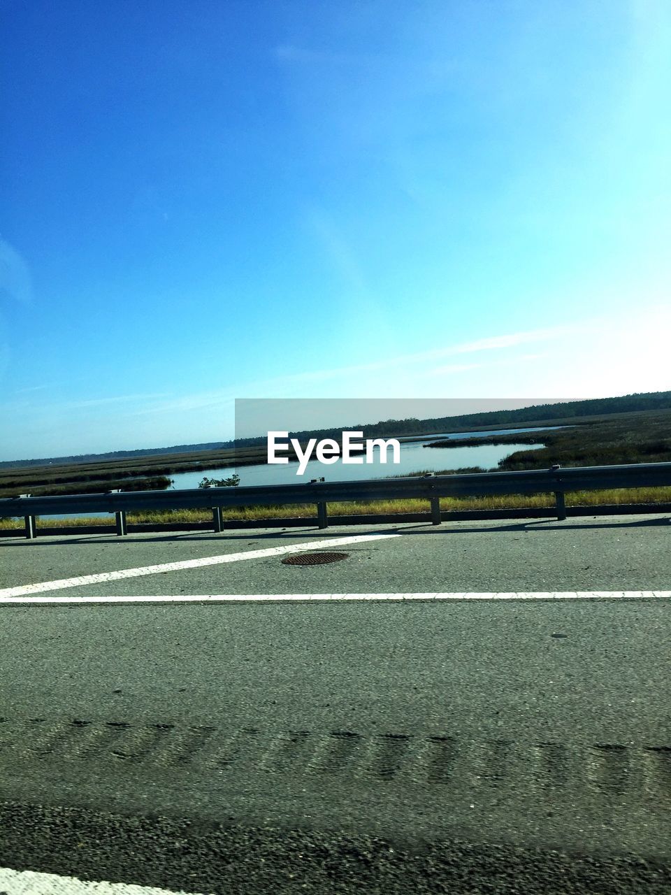 SCENIC VIEW OF BLUE SKY OVER WATER AGAINST THE BACKGROUND