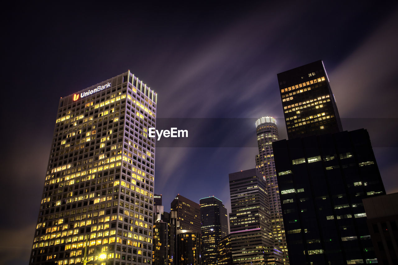 LOW ANGLE VIEW OF ILLUMINATED MODERN BUILDINGS AGAINST SKY