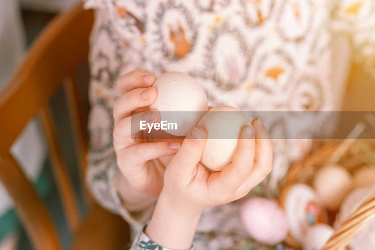 hand, egg, child, childhood, one person, holding, women, spring, food, indoors, baby, food and drink, female, adult, close-up, focus on foreground, celebration, selective focus, lifestyles, midsection, nature, easter, tradition, easter egg, domestic life