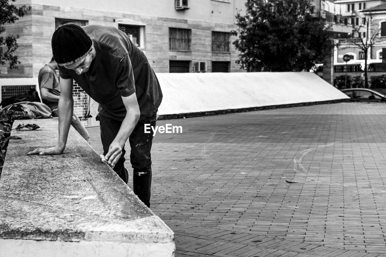 FULL LENGTH OF MAN WORKING ON STREET