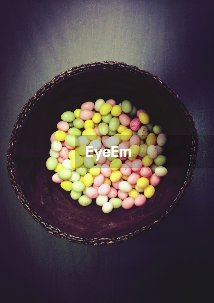 High angle view of colorful eggs in basket indoors