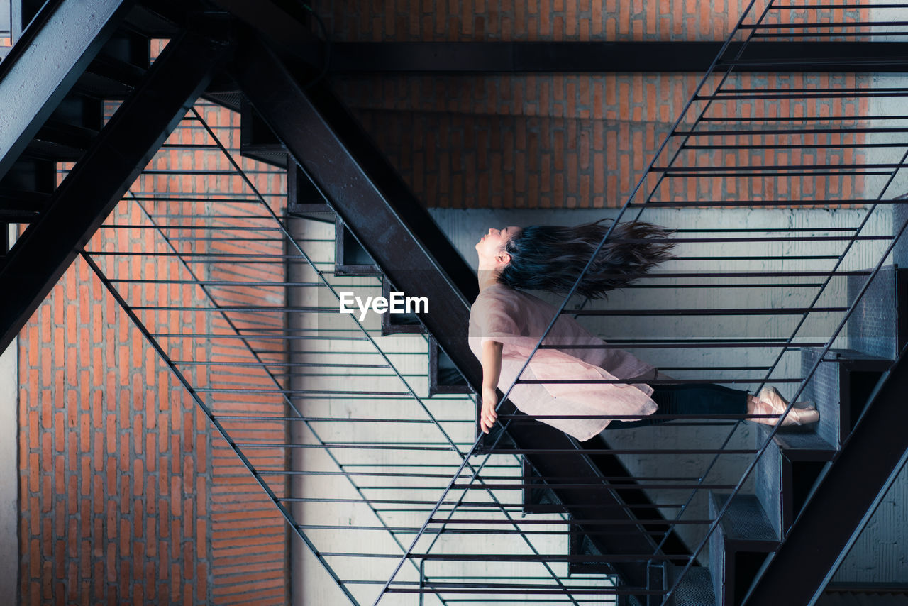 Side view of ballet dancer balancing on steps