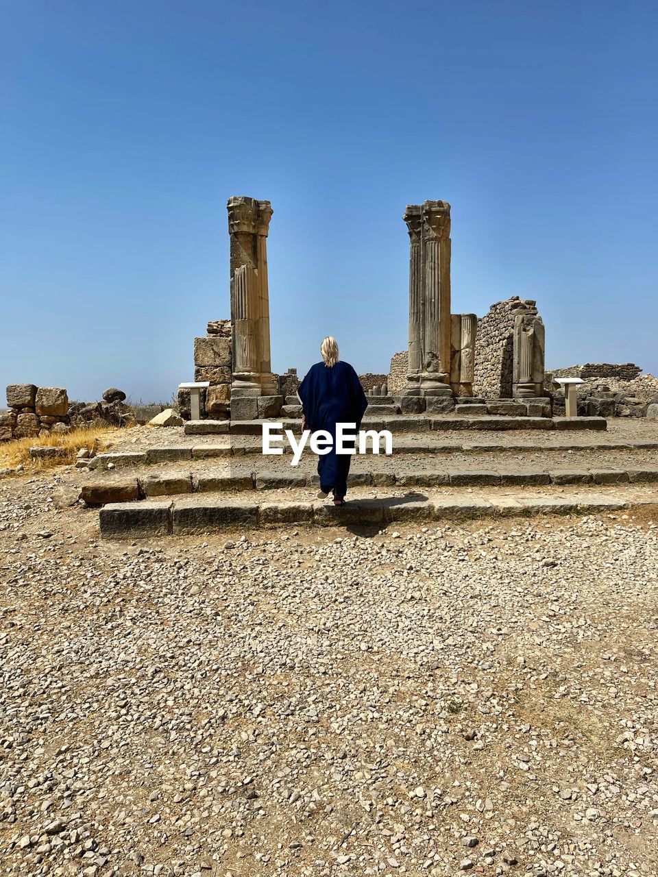 architecture, history, the past, sky, one person, ruins, monument, ancient history, ancient, travel, travel destinations, men, full length, old ruin, nature, landmark, built structure, adult, blue, temple, clear sky, archaeological site, outdoors, tourism, ancient civilization, rock, rear view, day, ruined, religion, sunny, temple - building, archaeology, land, lifestyles, standing, staircase, leisure activity, old, building exterior