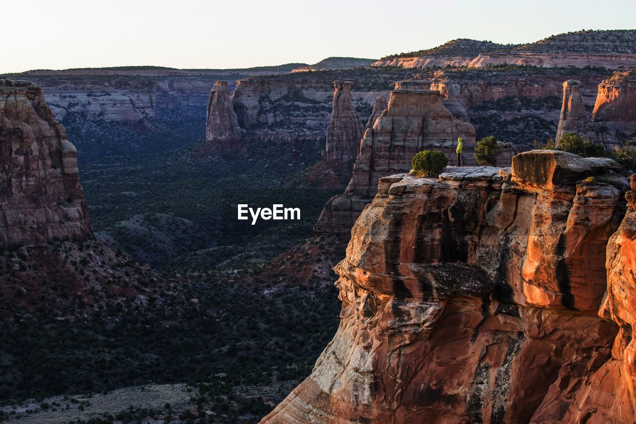A young woman enjoys a view over colorado national monument in co.