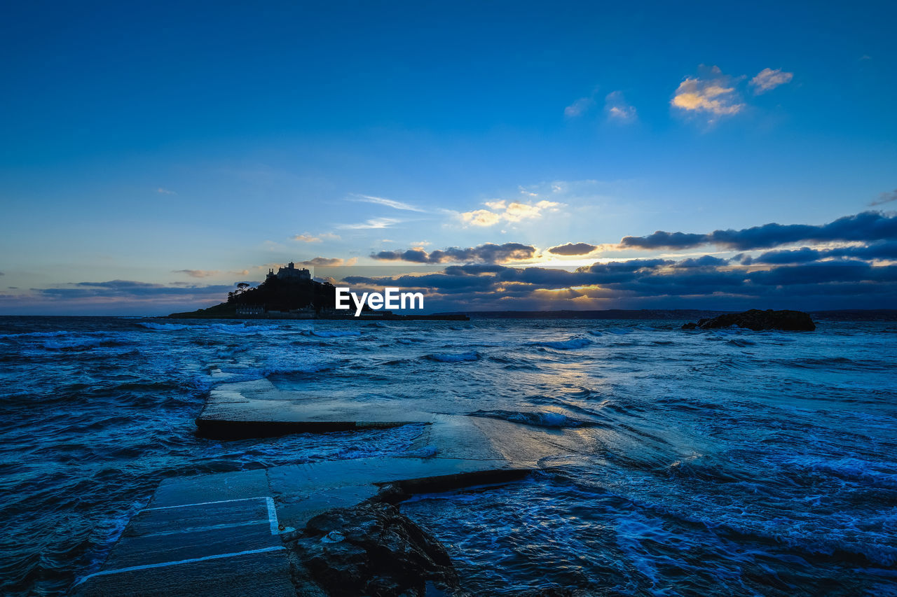 Scenic view of sea against blue sky